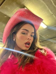 a woman wearing a red hat and fur coat