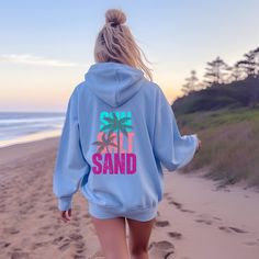 Embrace the beach lifestyle with our comfortable colorful, "Sun Salt Sand" beach hoodie, designed for those who live for sunny days, salty air, and sandy toes. This cozy and stylish coastal relaxed soft hoodie is a must-have for beach lovers, surfers, and anyone who enjoys the coastal vibe. Give off bright trendy summer themed vibes with this beach lover shirt on your next beach vacation or trip to the ocean!  You'll enjoy both the sunshine and this comfortable beachwear! Product Features:  * Pr Cheap Cotton Beach Hoodie, Cheap Hooded Beach Tops, Cheap Relaxed Fit Sweatshirt For Vacation, Cheap Long Sleeve Beach Hoodie, Sierra Beach Hoodie, Hoodie Summer Outfit, Beach Nights, Colorful Coastal, Sunshine Shirt