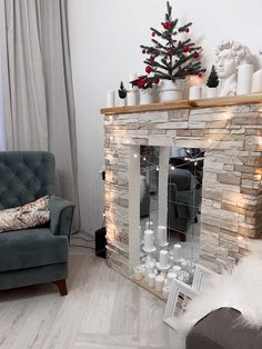 a living room filled with furniture and a christmas tree on top of a mantel