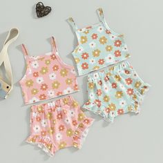 Welcome your little one to warm weather in this delightful FLOWER POWER Crop Top Summer Outfit! With its soft floral sleeveless crop top, perfectly paired with matching shorts in either pastel pink or pastel blue, your baby girl will look positively posh! Brighten up any sunny day with this one of a kind outfit. Summer never looked (or felt) so good! Cute Spring Vacation Sets, Summer Floral Print Pink Set, Cute Sleeveless Sets For Vacation, Light Blue Floral Print Sets For Spring, Cute Sleeveless Sets, Cute Sleeveless Matching Set, Sweet Sleeveless Cotton Set, Pink Floral Print Playwear Sets, Pink Floral Print Sets For Playwear