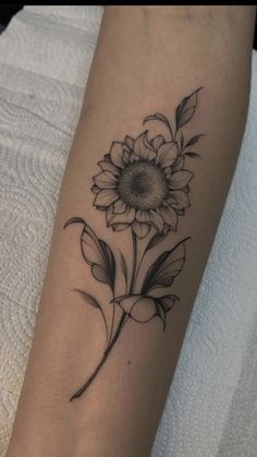 a sunflower tattoo on the arm