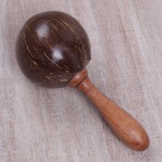 a close up of a wooden ball on a table top with a wood mallet