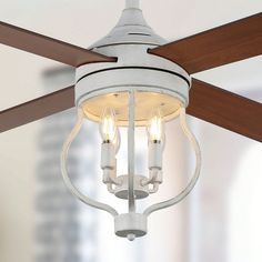 a ceiling fan with three lights hanging from it