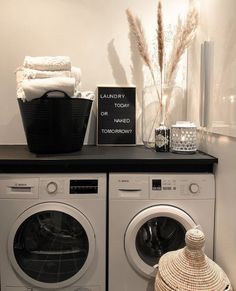 a washer and dryer sitting next to each other on top of a shelf