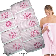 a woman in a pink and white striped robe is holding several personalized monogrammed towels