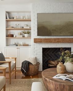 a living room filled with furniture and a flat screen tv mounted above a fire place