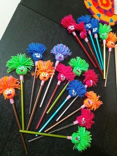 the colorful brushes are lined up on the table with each other's faces painted