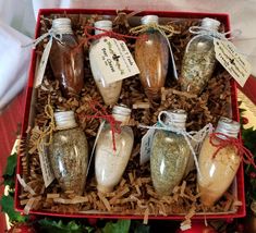 a box filled with lots of different types of spices and seasoning in bottles on top of a table