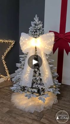 a white christmas tree with lights on it