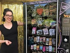 a woman standing in front of a vending machine with lots of cards on it