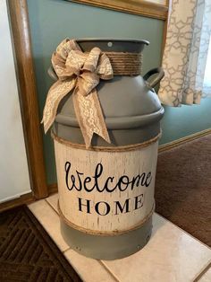 a welcome home sign is placed on top of a large metal container with a bow