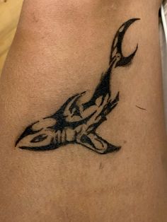 a tattoo on the leg of a person with a knife in it's hand