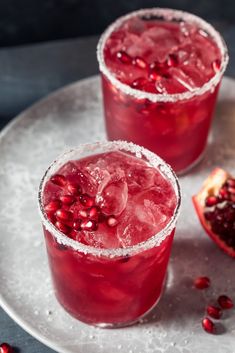 two pomegranate cocktails sit on a plate