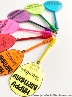 several different colored tags with writing on them