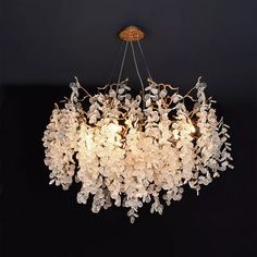 a chandelier with many lights hanging from it's sides and leaves on the bottom