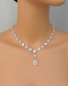 "Brilliant and full of sparkle! This necklace is decadent. The pictures do not do it justice! Sleek and elegant, this necklace truly make a statement! The quality of my pieces are second to none. I use high quality Pure Brilliance crystals. Matching Julienne pieces: https://www.etsy.com/shop/CrystalCorridor?search_query=julienne Matching bracelet sold separately: https://www.etsy.com/listing/250443255/rosegold-bridal-bracelet-crystal-wedding I've designed the Julienne full crystal necklace to cr Wedding Costume Jewelry Teardrop, Elegant Jeweled Drop Necklace For Wedding, Elegant Dangle Diamond Necklace For Wedding, Sparkling Dangle Necklaces For Wedding, Elegant Sparkle Necklace For Anniversary, Gold Pear-shaped Diamond Necklace For Wedding, Sparkling Dangle Necklace For Wedding, Wedding Costume Jewelry Necklaces With Sparkling Stones, Gold Drop Diamond Necklace For Wedding