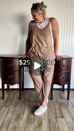 a woman standing in front of a wooden dresser