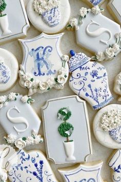 decorated cookies with blue and white designs on them are arranged in the shape of letters