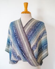 a blue and white shawl on a mannequin