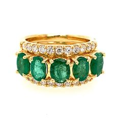 The splendor of green emeralds are magnificently highlighted with round cut diamonds and sumptuous yellow gold. Along the center of this ring are five oval shape emeralds weighing 2.55 ct. in total with their eye catching green color. On either side of these stones are lines of round brilliant cut diamonds weighing 0.65 ct. total and displaying white F color and eye clean SI-1 natural clarity. They're all set in this 14 kt. yellow gold ring we can make to your exact finger size! Round Diamond Ring, Yellow Gold Ring, Multi Stone Ring, Round Brilliant Cut Diamond, Round Cut Diamond, Round Brilliant Cut, Yellow Gold Rings, Oval Cut, Round Brilliant