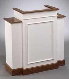 a white cabinet sitting on top of a wooden floor