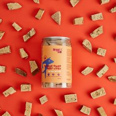 a jar of dog treats sitting on top of a red surface