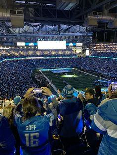 a football stadium filled with people watching the game