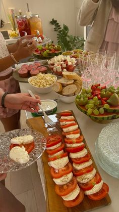 people standing around a table filled with food