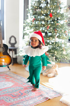 Celebrate the holiday season with this adorable, festive elf costume! With cozy cotton pajamas, a frilled collar and a warm Santa hat, it’s the cutest pajama for Christmas morning and wearable all winter long to warm up any chilly day. #christmas #holiday #christmaself #kidscottonpjs #christmaspjs #elfcostume Holiday Spirit Week, Santa's Helper Costume, Elf Pajamas, Frilled Collar, Red Santa Hat, Pajama Costume, Baby Kostüm, Elf Costume, Create Picture