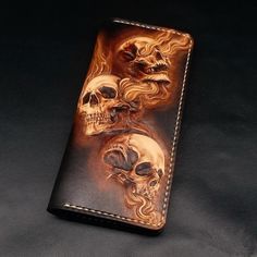 a wallet with three skulls painted on it