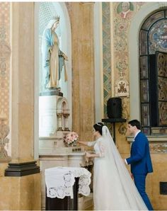 a bride and groom standing in front of the alter at their wedding ceremony, holding hands with each other