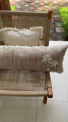 two wicker chairs with pillows on them