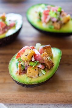 avocado halves filled with different types of food