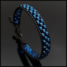 This handmade stylish blue hematite  bracelet will perfectly fit with your formal style. It is a perfect gift for you and all your loved one for all special days such as birthday, valentine's day, father's day, anniversary etc. Wrap is durable 1,5 mm polyester black rope. For closure of our high quality bracelet we used zamak alloys button with 2 optional closure buttonhole. Please kindly check your wrist size according to the picture of measurement instruction and order the same size.  All our designs prepare by hand according to the your given sizes with love. We offer 8 size option between 5.9-8.7 inches (15-22 cm) , please DM us to demand different wrist size. Used materials; 2*6 mm two hole pig nose bluehematite 1.5 mm black korean rope 1 cm zamak alloys button ☆ABOUT US☆ https://www. Modern Blue Bracelet For Gift, Modern Adjustable Blue Braided Bracelets, Modern Adjustable Blue Braided Bracelet, Modern Blue Adjustable Bracelets, Modern Adjustable Blue Bracelets, Modern Blue Beaded Bracelets For Gift, Modern Blue Beaded Bracelets As Gift, Modern Blue Leather Bracelet Gift, Elegant Blue Leather Bracelet For Gift