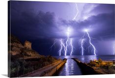 there are many lightnings in the sky over the water