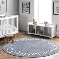 a baby's room with white furniture and gray rug