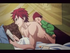 a man laying in bed next to a little boy with red hair and green shirt