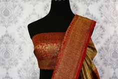 Traditional beige Banarasi tussar saree for special occasions. The saree has a beautiful antique red zari border and pallu which makes it oh-so-beautiful. It comes with a matching red blouse piece. Shop online at Pure Elegance or visit our store in USA! Disclaimer: The actual product may vary slightly from the image. These are custom orders, hence expect slight variation in color, placement of the motif or buta. ESTIMATED DELIVERYBecause this is a custom order, it would take about 4 weeks from t Red Raw Silk Saree With Border, Tussar Saree, Indian Handloom, Red Border, Pure Elegance, Fashion Journals, Red Blouse, Banarasi Saree, Traditional Fabric