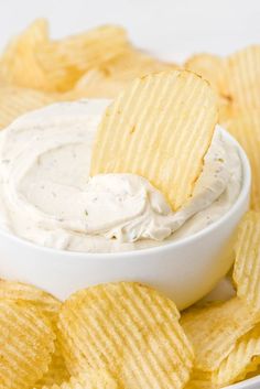 a white bowl filled with chips and dip