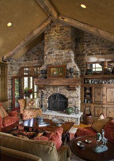 a living room filled with lots of furniture and a fire place in the middle of it