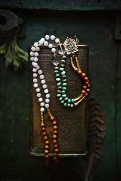 "This smaller size (6mm) mala necklace is made with a powerful combination of white Moonstone, green Chrysoprase, Citrine, tribal brass and slightly fragrant Sandalwood beads. It's finished with an artisan bronze Tree of Life pendant (Crescent Moon on the back side). This delicate and earthy piece is great for new beginnings..! Total necklace length is about 36 inches - the pendant reaches the Solar Plexus on a medium height person. It's lightweight and comfortable to wear everyday - last pictur Nature-inspired White Necklace With Natural Stones, Nature-inspired White Necklaces For Healing, White Nature-inspired Necklaces For Healing, Bohemian White Jade Necklaces, Artisan Jade Jewelry For Meditation, White Beaded Necklaces With Gemstone Beads For Healing, Spiritual Amazonite Crystal Necklace With Gemstone Beads, Healing White Gemstone Beaded Necklaces, Spiritual White Necklaces With Natural Stones