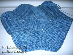 a blue crocheted scarf with buttons on it