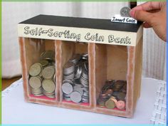 there is a small box with coins in it that says self - sorting coin bank