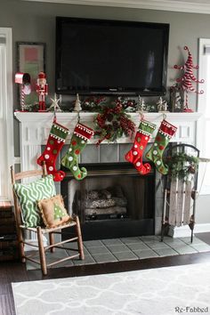 a living room decorated for christmas with stockings and stockings hanging on the fireplace mantel