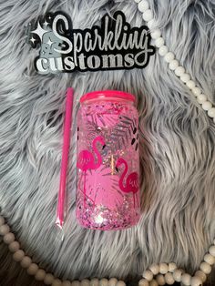 a pink flamingo tumbler next to a sparkle stick