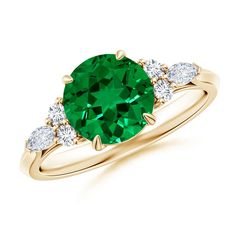 a green ring with three diamonds on the side and an oval cut emerald in the center