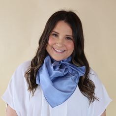 Brunette model wearing a short sleeve, white top with a slate blue scarf tied around her neck. This model is pictured in front of a beige background. Blue Silk Scarf As Gift, Wild Rags, Giddy Up Glamour, Wild Rag, College Station, New Line, Slate Blue, Purse, Silk