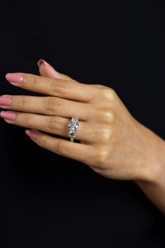 a woman's hand with a diamond ring on it