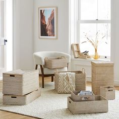 a living room filled with lots of furniture and baskets on top of a white rug