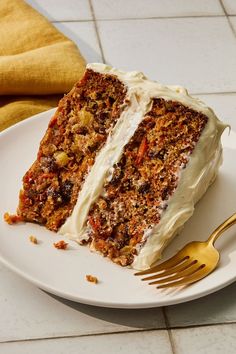 a piece of carrot cake on a plate with a fork